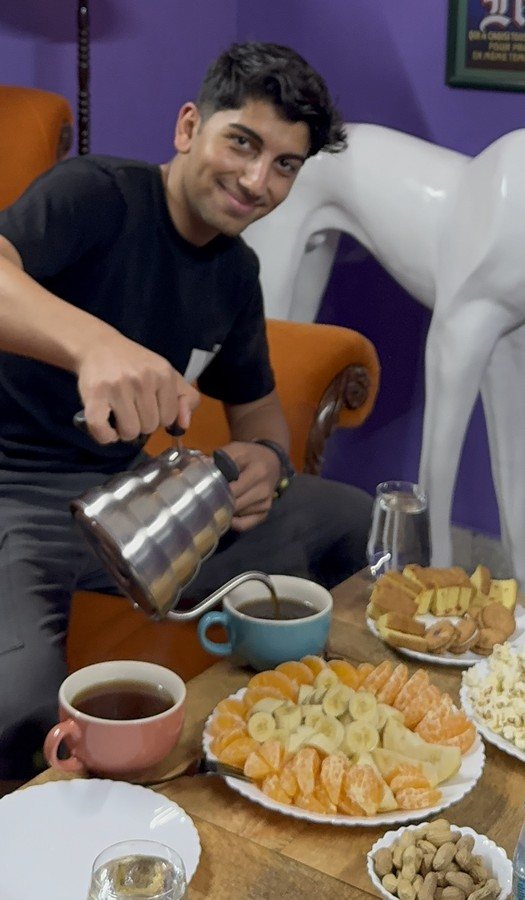Yiğit pouring coffee